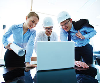 A person showing something on latop to their team